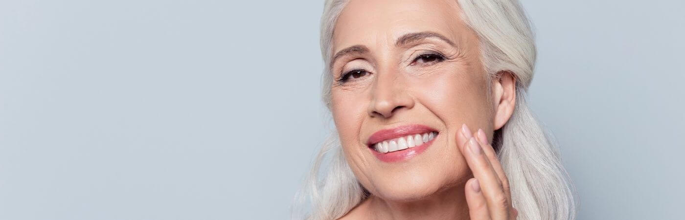 Old Woman with Grey Hair Stroking Face