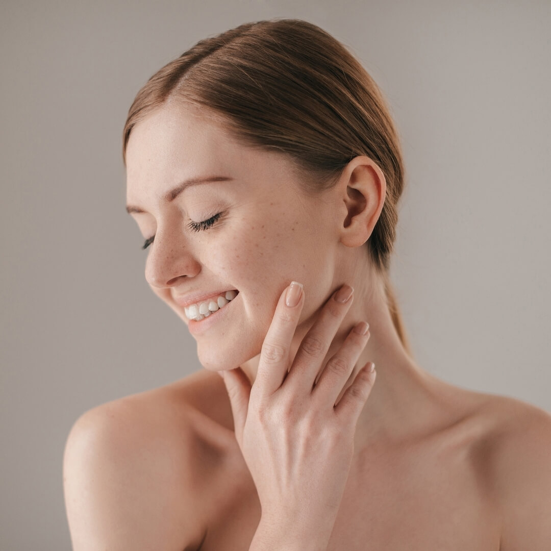Women Smiling with Hand on Face