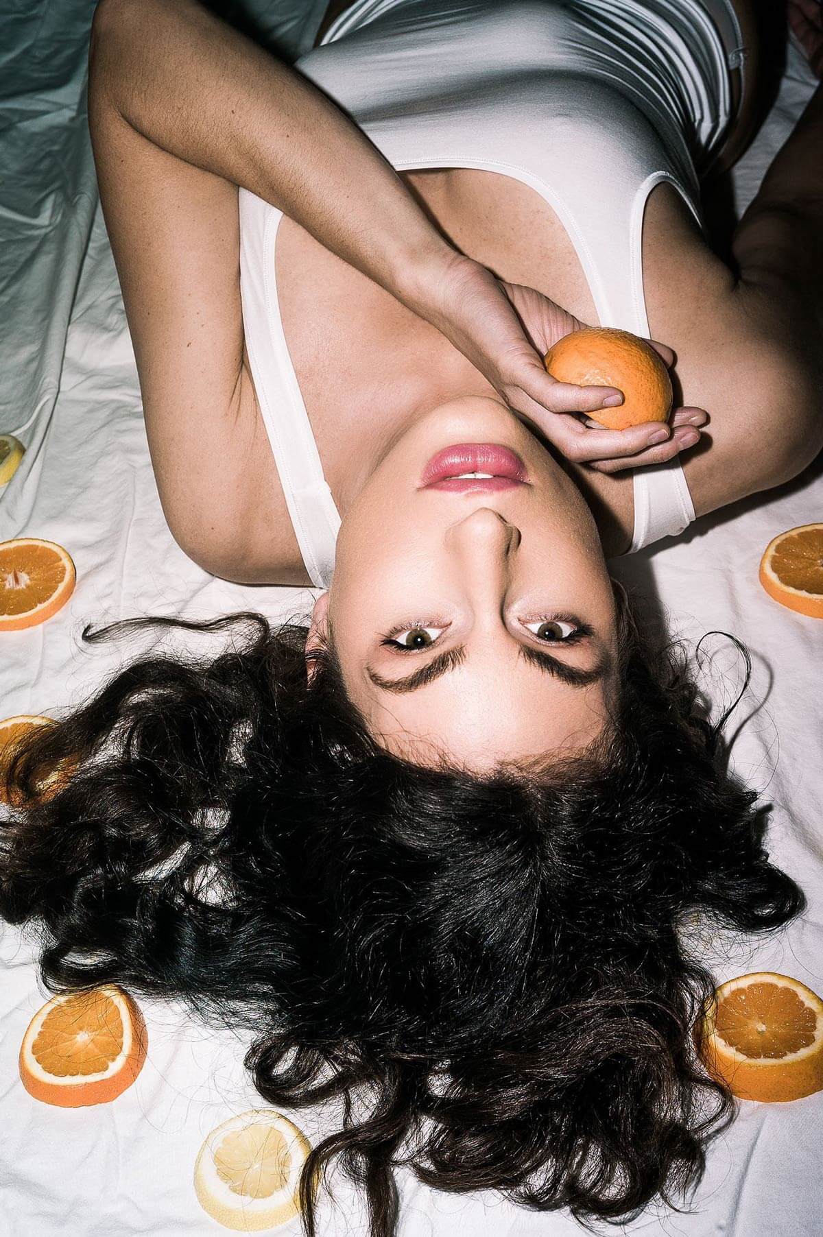 Daniella Surrounded by Oranges